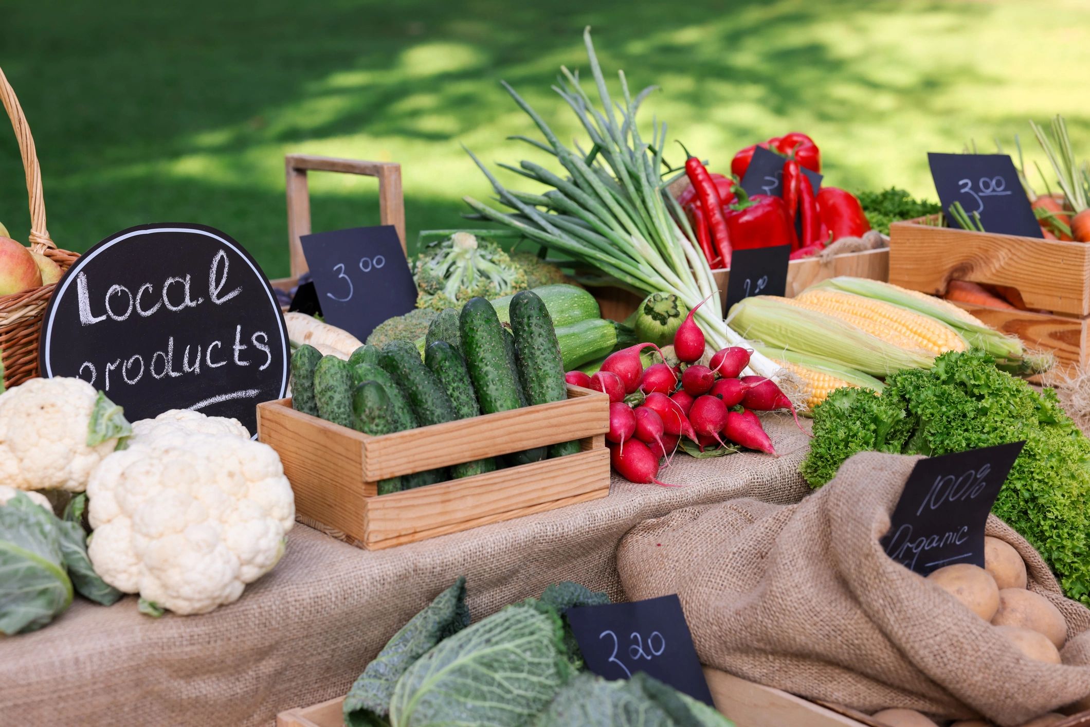 Assorted vegetables displayed at a farmers market stand